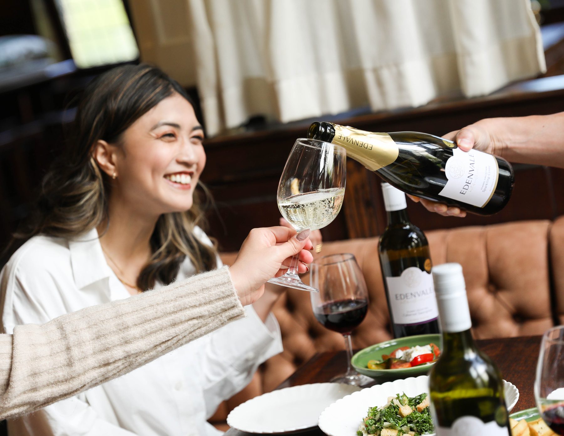 Pouring Edenvale Sparkling Cuvee at a dinner with friends
