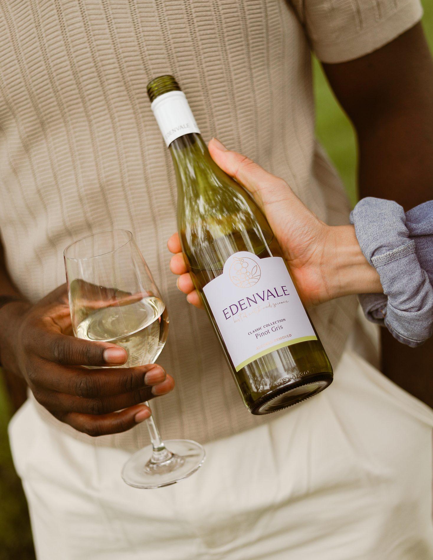 Holding a glass and a bottle of Edenvale Pinot Gris