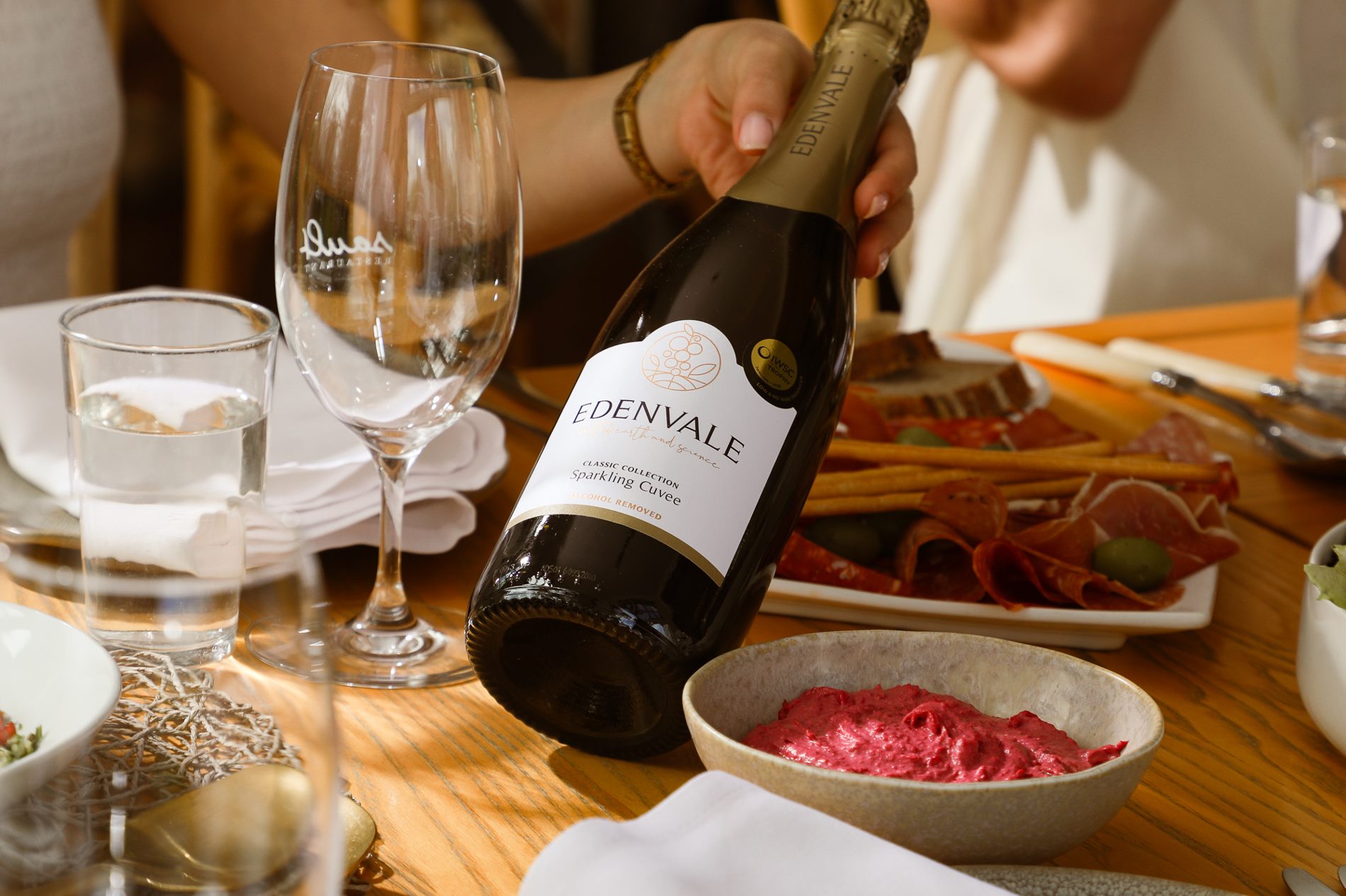 Pouring Edenvale Sparkling Cuvee over a shared lunch