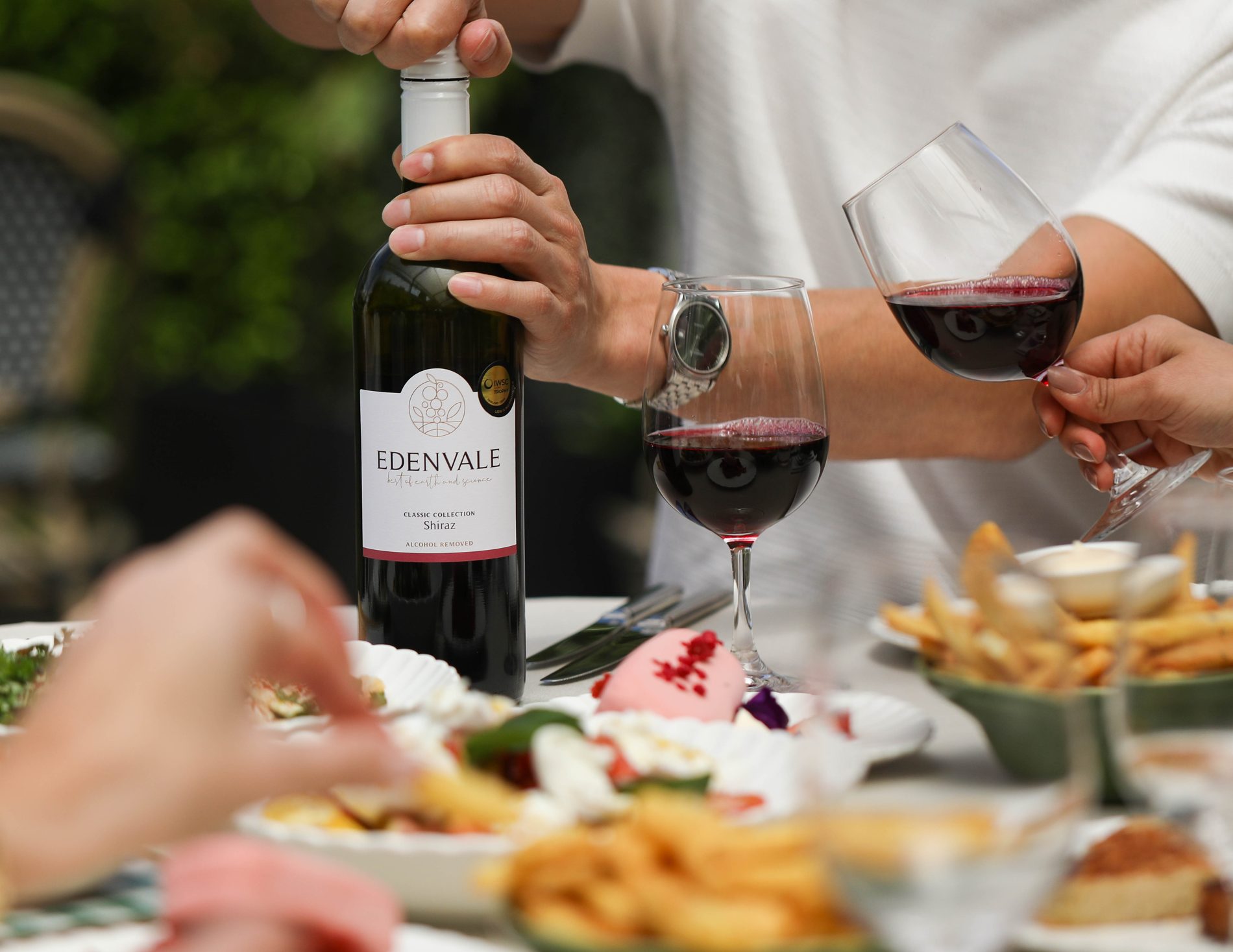 Pouring Edenvale Shiraz at a lunch table