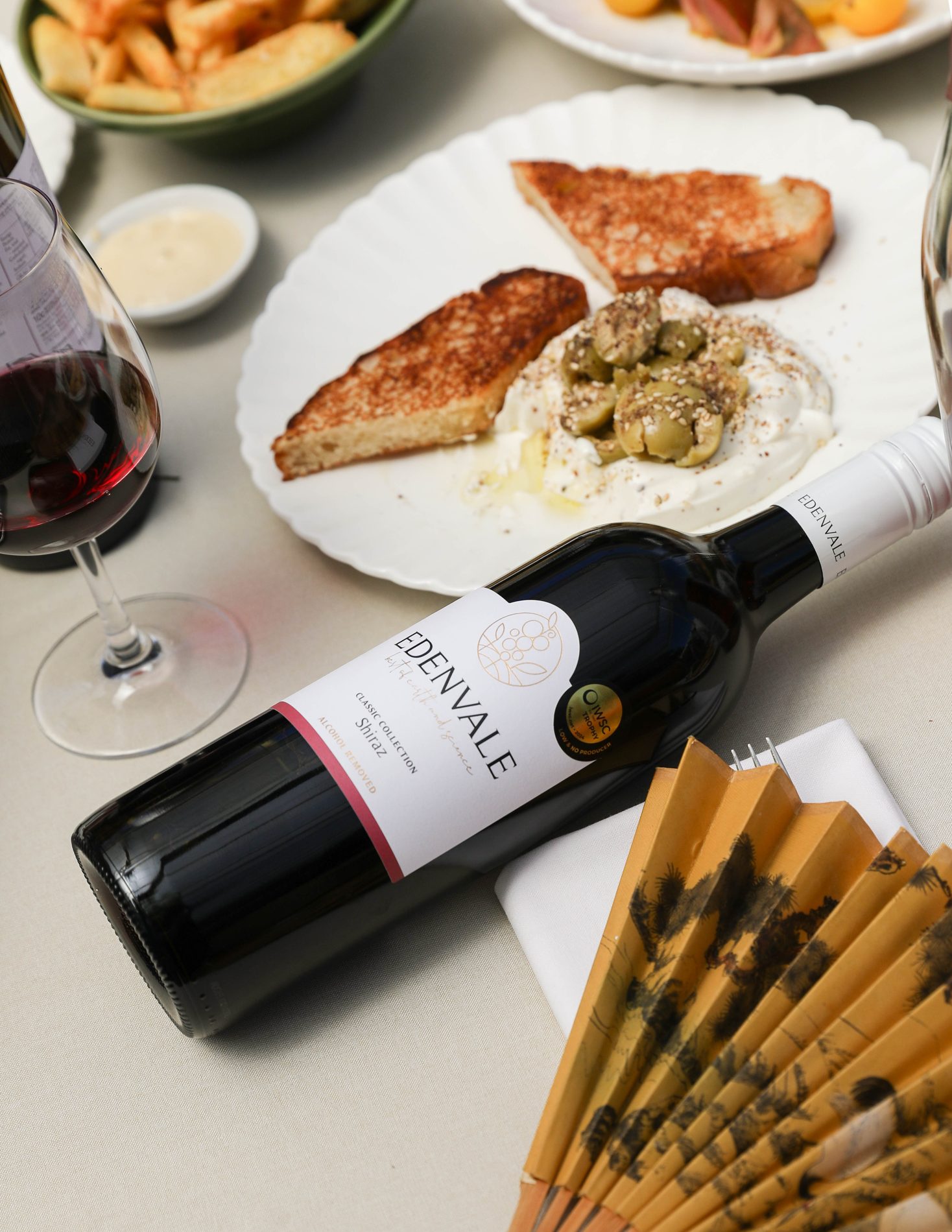 A bottle of Edenvale Shiraz beside a share plate